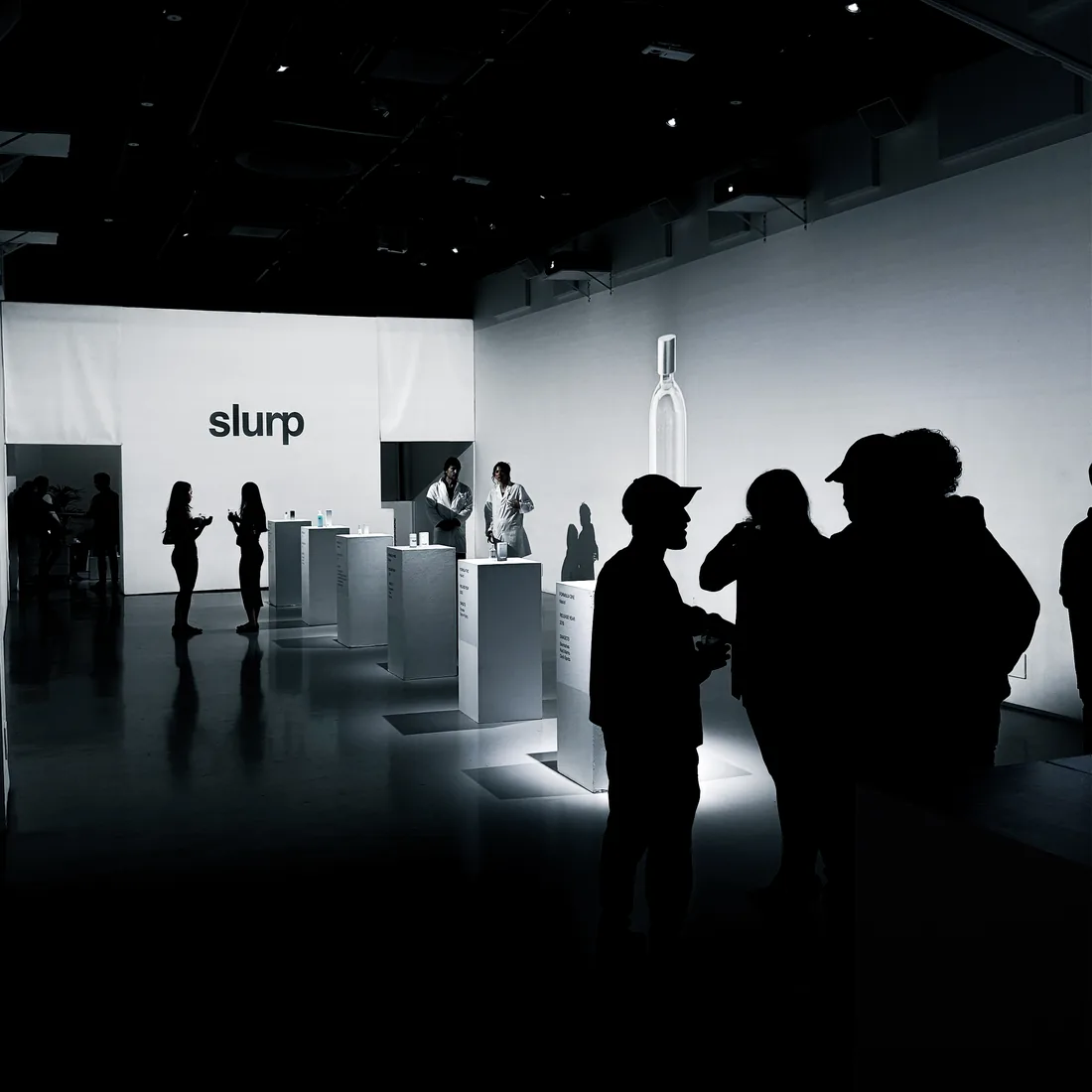 Guests in silhouette at the Slurp Laboratories holiday event